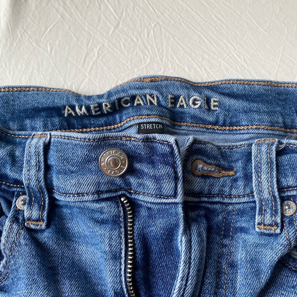american eagle stretchy jeans that are ripped. they are wide legged and size 4